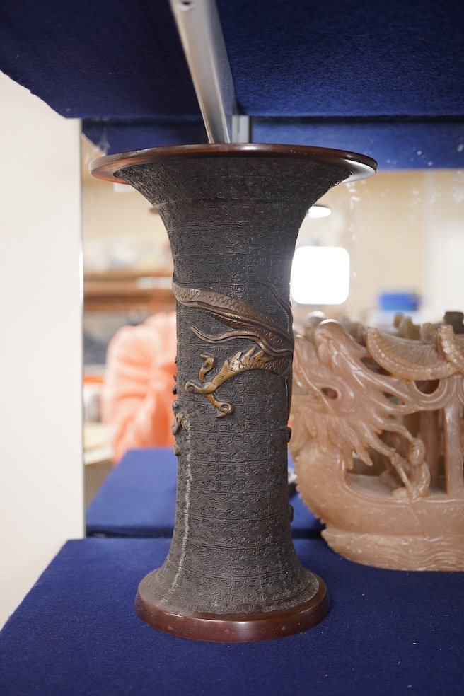 A Japanese bronze dragon vase, Chinese bronze immortal on donkey, and soapstone dragon boat carving, bronze vase 24cm high. Condition - good